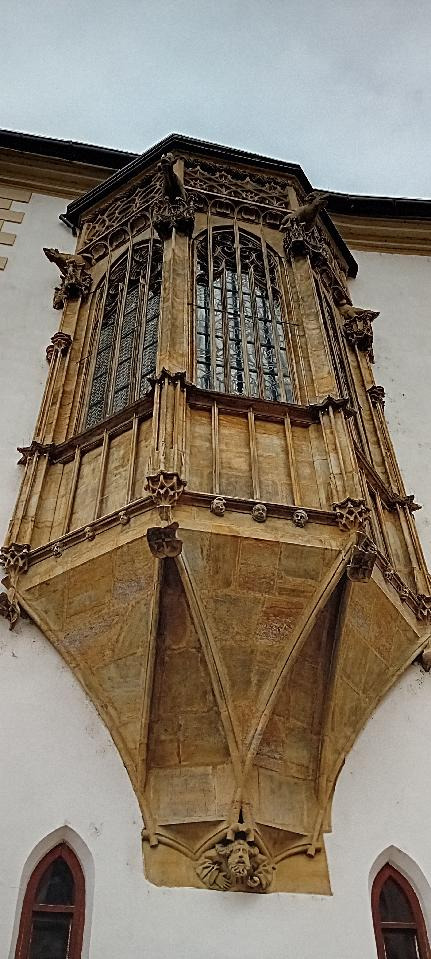 J. Králová: Arkýř kaple sv. Jeronýma na jižní fasádě olomoucké radnice v Olomouci. Úplně dole vidíme grotesku: část postavy, jak natahuje ruku. Podle pověsti kamenický mistr se sám zpodobnil, jak čeká na peníze, protože radní mu nevyplatili mzdu, na které se usnesli. Pomstil se jim také tím, že karikatury jejich tváří vytesal výše (maskarony). Jiná pověst říká, že to jsou zkamenělé tváře proradných radních. Nejvýše jsou čtyři figury zoomorfních chrličů &ndash; prase, kozel, beran,medvěd. Jsou symbolickým zpodobněním lidských neřestí.